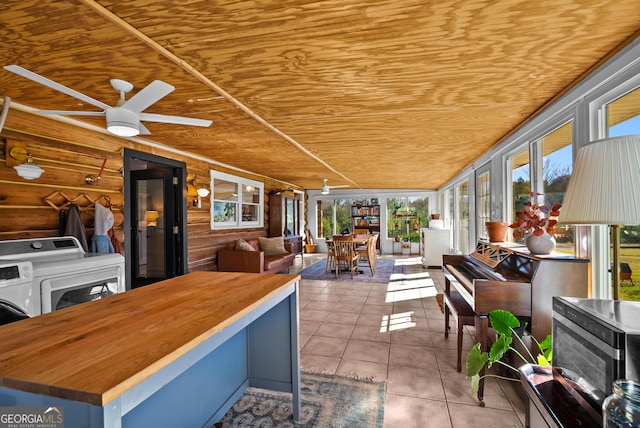 sunroom featuring ceiling fan, washer / clothes dryer, and wooden ceiling