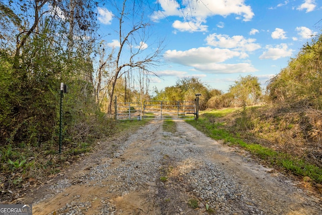 view of road featuring a gate and a gated entry