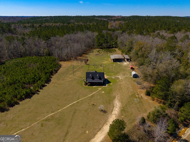 aerial view featuring a view of trees and a rural view