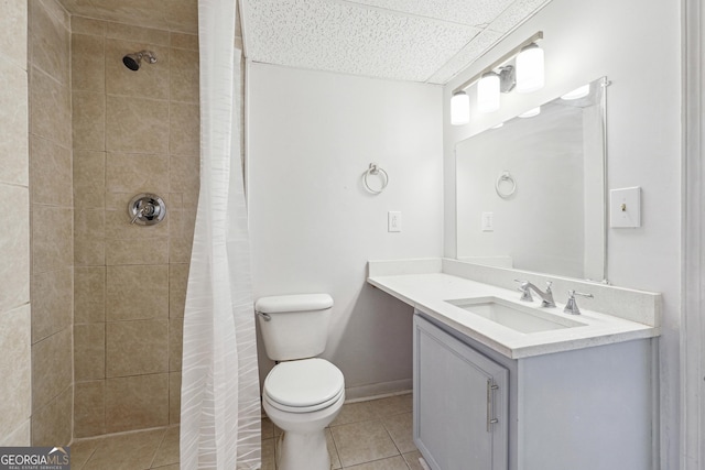 full bath with baseboards, toilet, a tile shower, tile patterned floors, and vanity