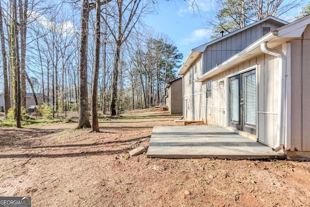 view of yard with french doors and a patio