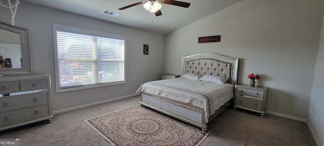 carpeted bedroom with visible vents, a ceiling fan, baseboards, and vaulted ceiling