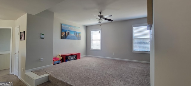 playroom with carpet flooring, ceiling fan, and baseboards