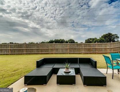 view of patio with a fenced backyard and outdoor lounge area