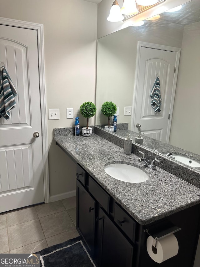 bathroom with vanity, tile patterned floors, and baseboards