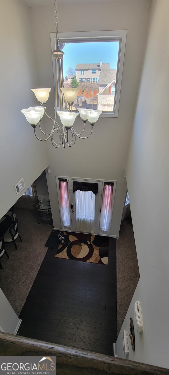 carpeted dining space with visible vents