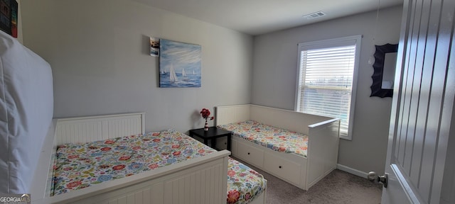 bedroom featuring light colored carpet, visible vents, and baseboards