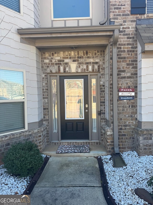 entrance to property with brick siding