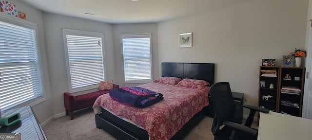 bedroom featuring visible vents, baseboards, and carpet