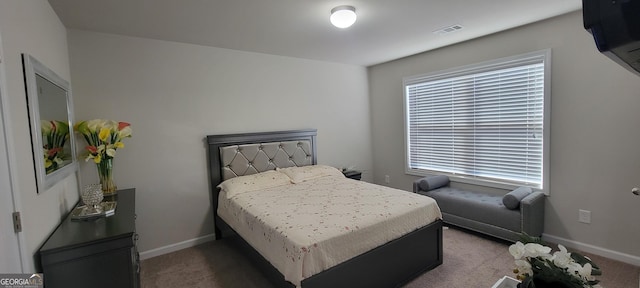 carpeted bedroom featuring baseboards and visible vents