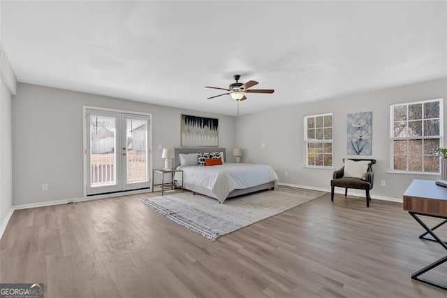 bedroom featuring a ceiling fan, access to outside, wood finished floors, and baseboards