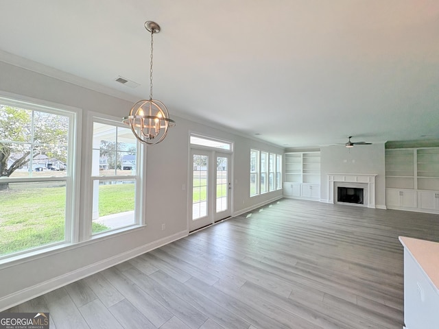 unfurnished living room with visible vents, baseboards, light wood finished floors, a fireplace, and ornamental molding