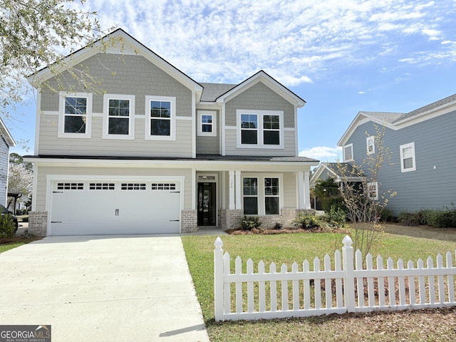 craftsman house with brick siding, fence, a front yard, a garage, and driveway