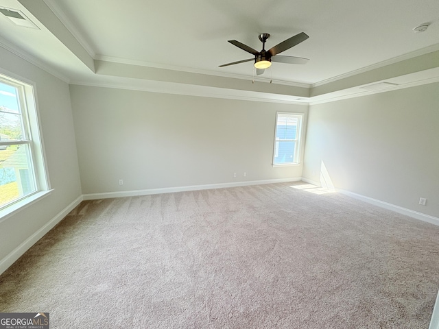 spare room featuring carpet floors, a ceiling fan, baseboards, and ornamental molding