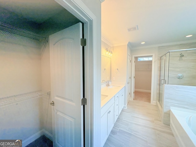 bathroom with a spacious closet, visible vents, crown molding, a stall shower, and a bath