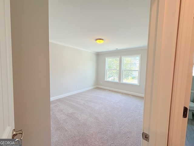 unfurnished room with baseboards, carpet, and ornamental molding