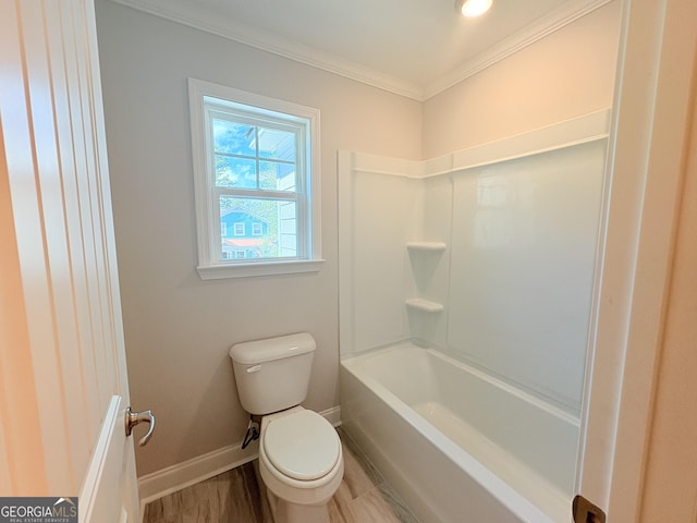 bathroom featuring crown molding, toilet, and baseboards