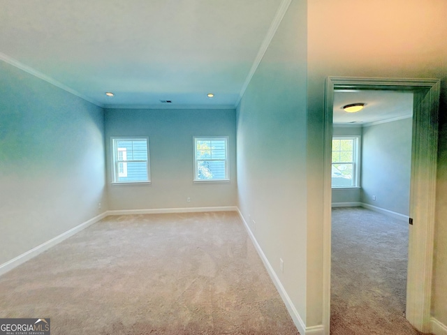 carpeted empty room with baseboards and ornamental molding