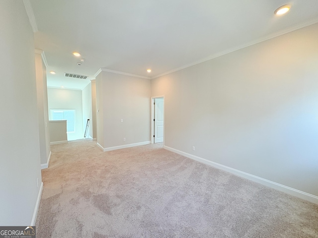 empty room with visible vents, light carpet, ornamental molding, recessed lighting, and baseboards