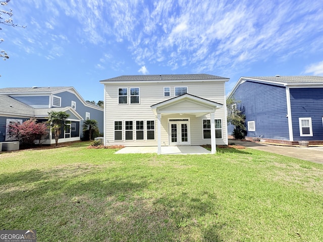 back of property featuring a patio area, central AC unit, a lawn, and french doors