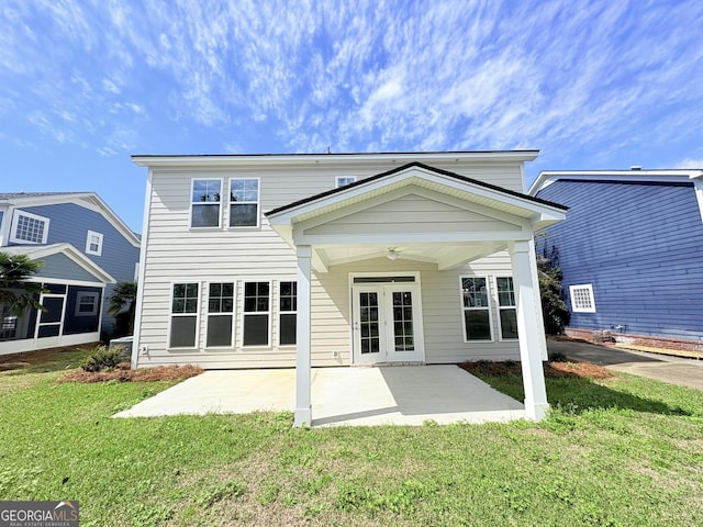 back of property featuring a lawn, a patio, and ceiling fan