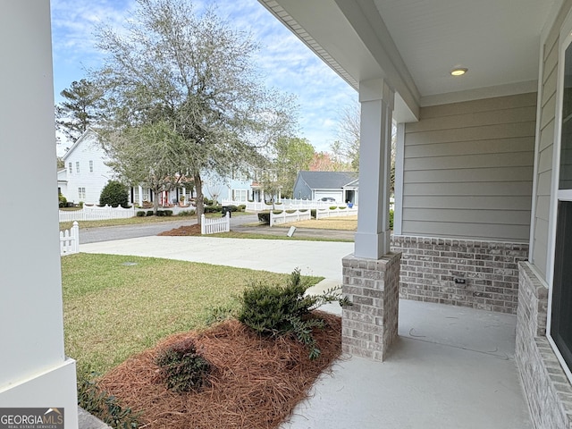 view of yard with a residential view and a porch