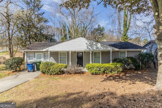 single story home with a porch and brick siding