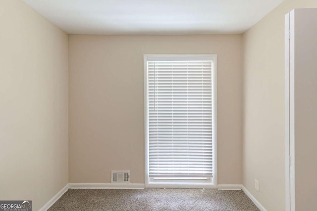 carpeted empty room with baseboards and visible vents