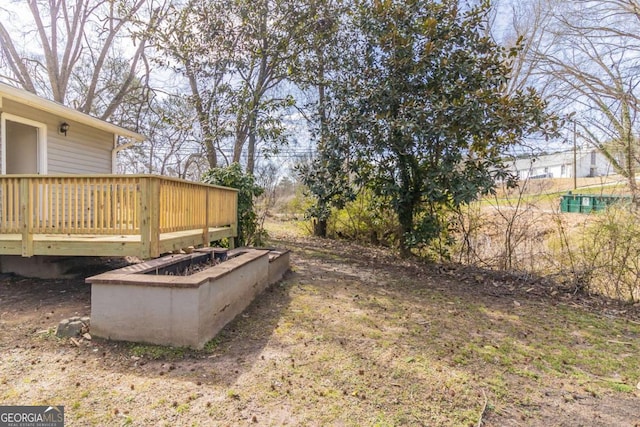 view of yard featuring a wooden deck