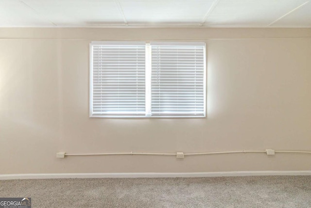 carpeted empty room with baseboards