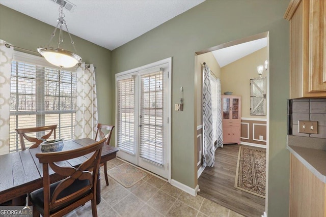 dining room featuring visible vents and vaulted ceiling