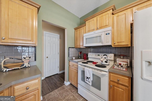 kitchen featuring light brown cabinetry, white appliances, a textured ceiling, and tasteful backsplash