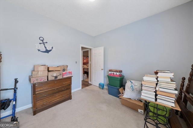 carpeted bedroom featuring baseboards and a textured ceiling