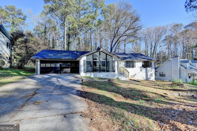 single story home with an attached garage and driveway