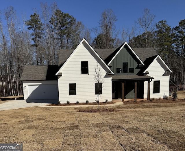 modern farmhouse with concrete driveway, a garage, board and batten siding, and roof with shingles