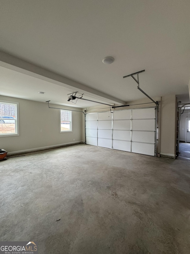 garage with a garage door opener and baseboards