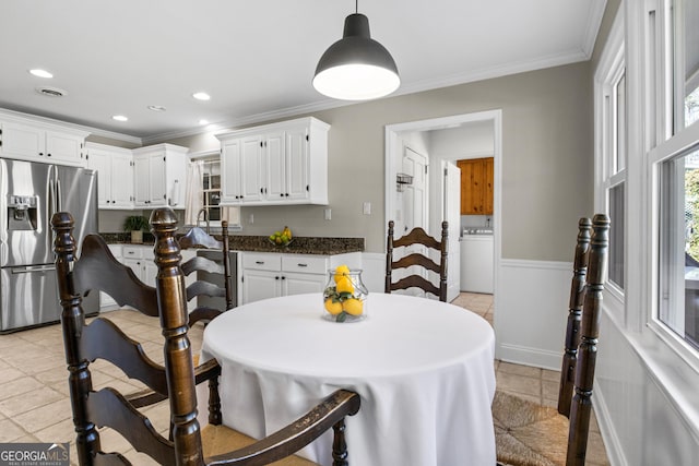 dining space featuring light tile patterned flooring, recessed lighting, washer / clothes dryer, wainscoting, and crown molding