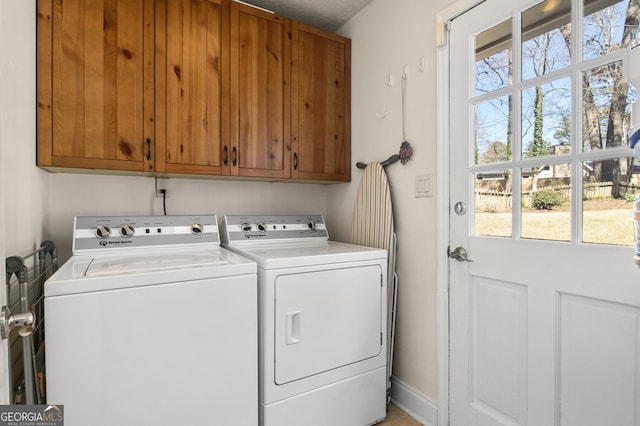 washroom with separate washer and dryer, plenty of natural light, and cabinet space