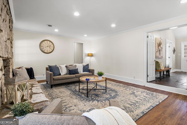 living area featuring baseboards, wood finished floors, and ornamental molding