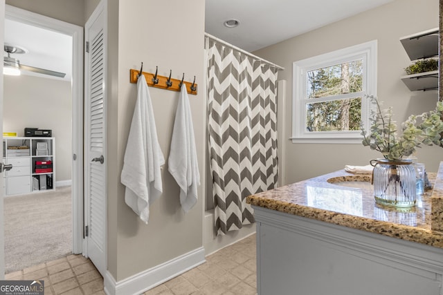 bathroom featuring baseboards and vanity