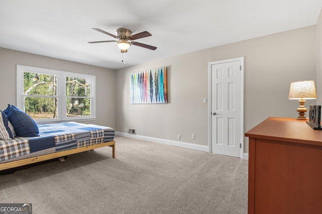 bedroom featuring a ceiling fan, baseboards, visible vents, and light carpet