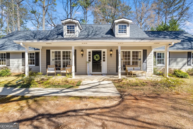 view of front facade with a porch and roof with shingles