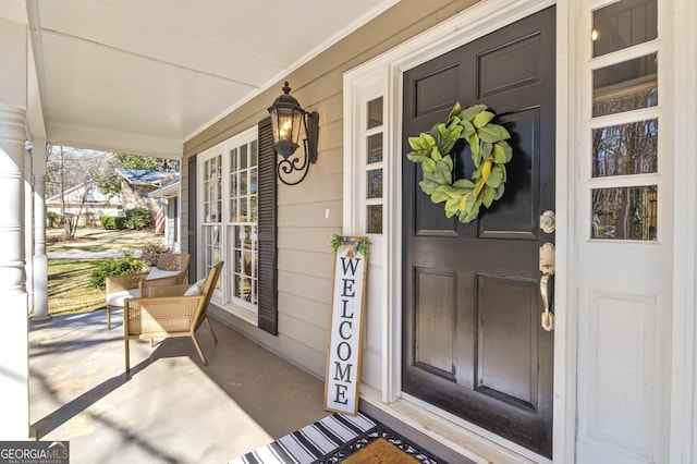 view of exterior entry with covered porch