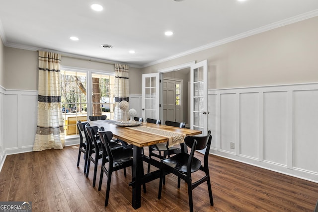 dining room featuring visible vents, ornamental molding, recessed lighting, a decorative wall, and dark wood-style flooring