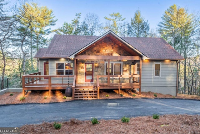 chalet / cabin featuring roof with shingles