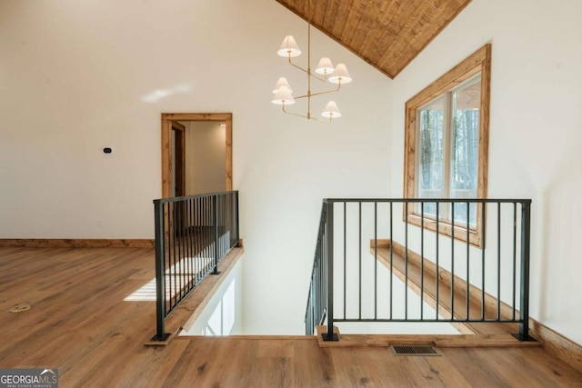 interior space featuring visible vents, wooden ceiling, baseboards, and wood finished floors