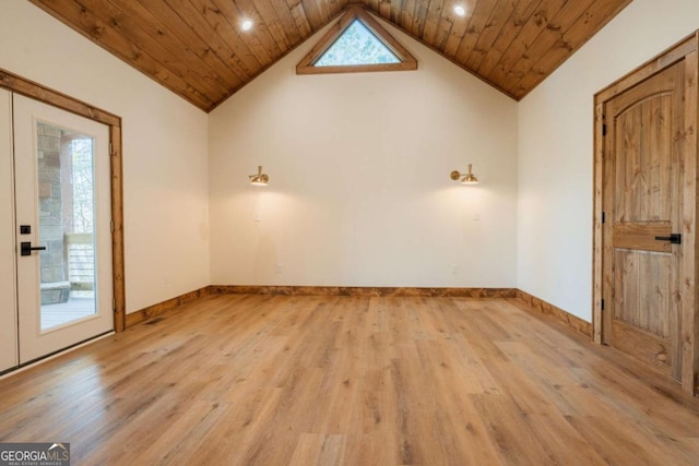 spare room with wood ceiling, light wood finished floors, and a healthy amount of sunlight