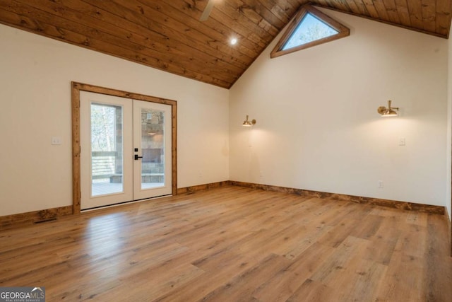 empty room featuring baseboards, wood ceiling, french doors, wood finished floors, and high vaulted ceiling