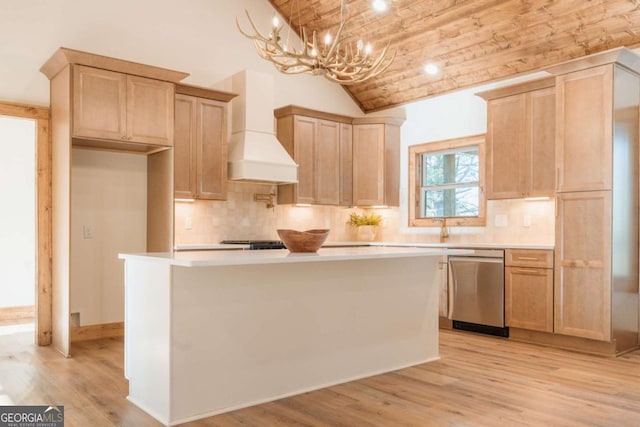 kitchen featuring a center island, light countertops, light wood-type flooring, custom range hood, and stainless steel dishwasher