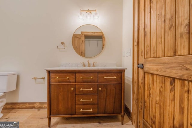 bathroom featuring toilet and vanity